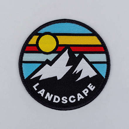 Woven mountain landscape patch laid flat