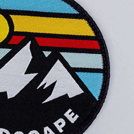 Woven mountain landscape patch close up